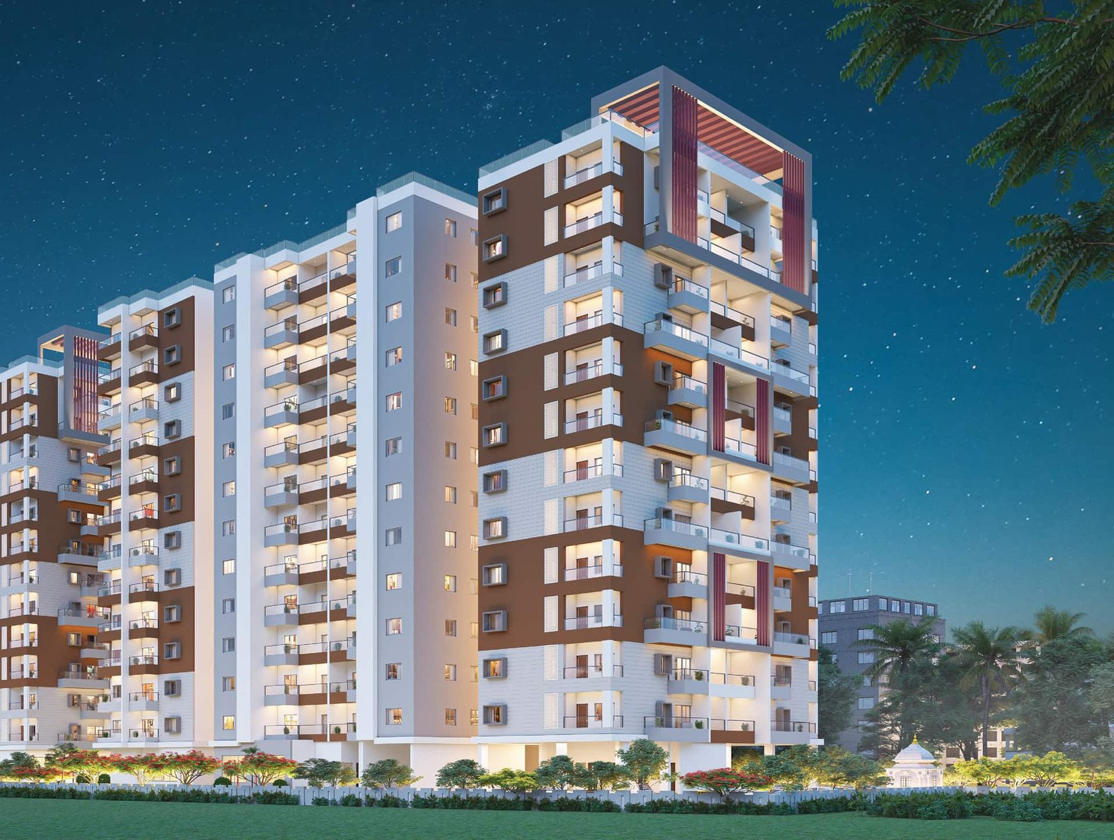 Lal Chand Eco Heights towers lit up at night with landscaped lawns in the foreground